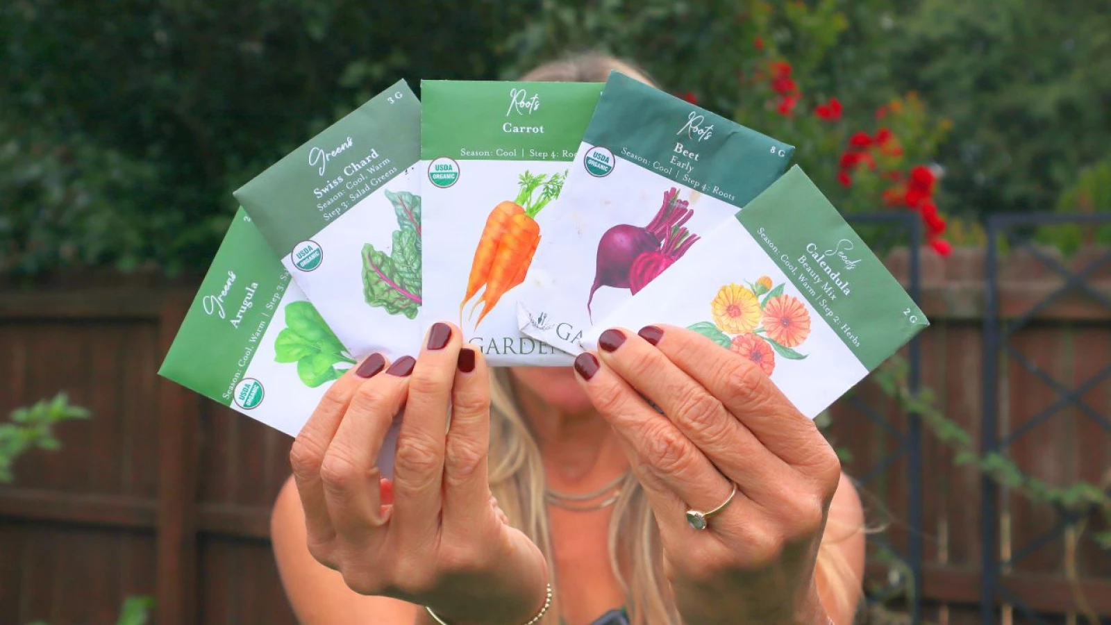 hands holding seed packs