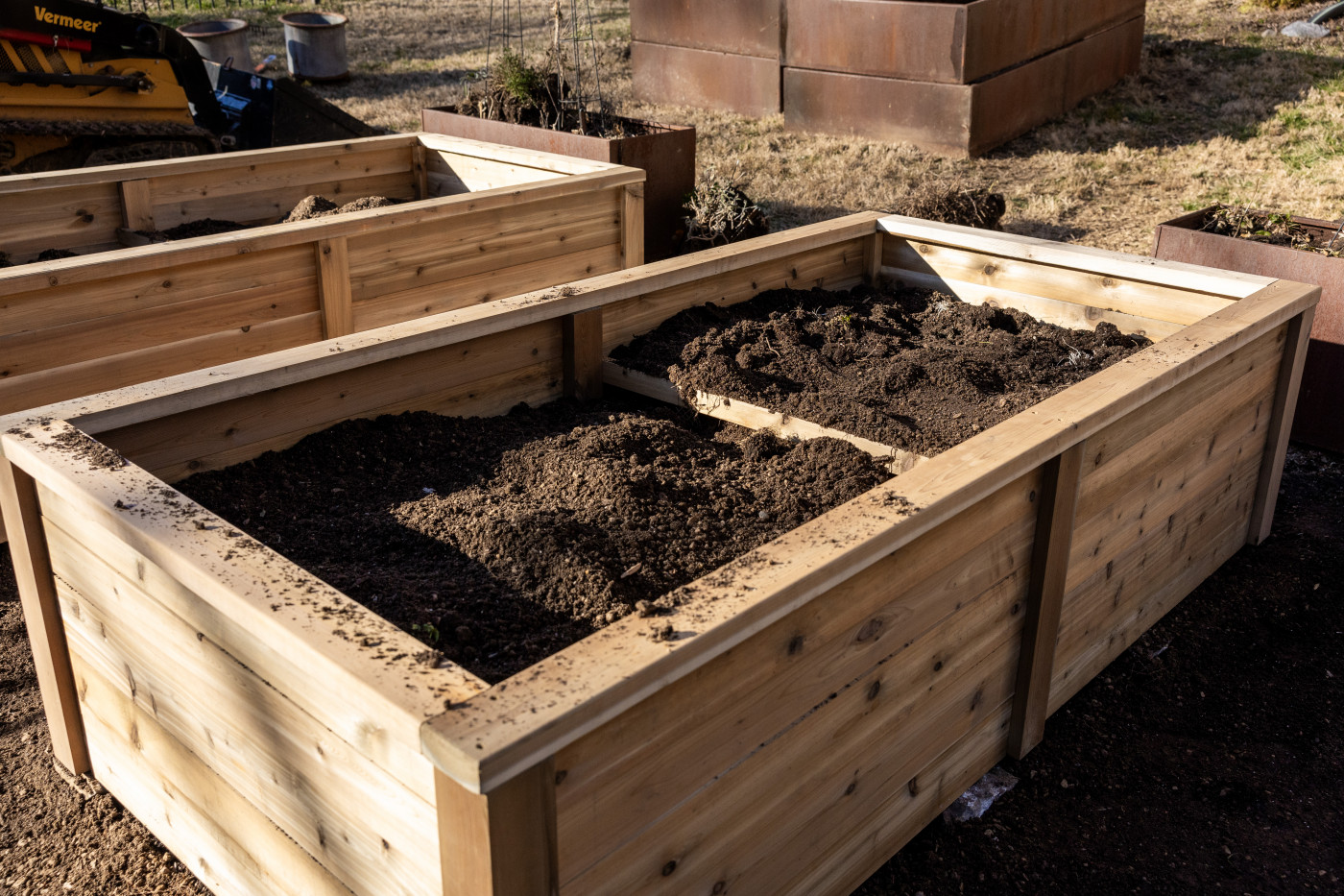 A cedar raised bed with new soil on top