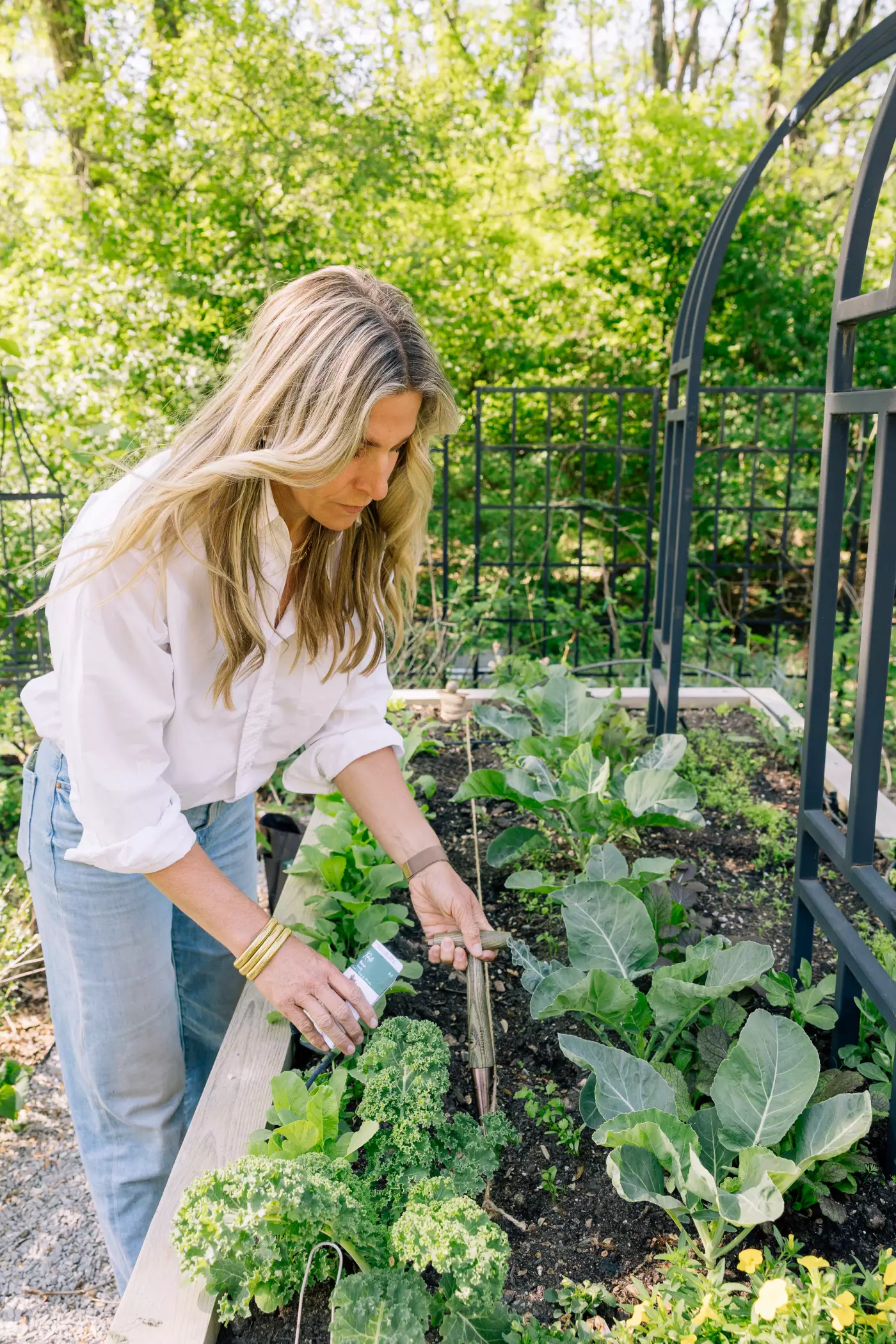 A photo of a gardener planting seeds