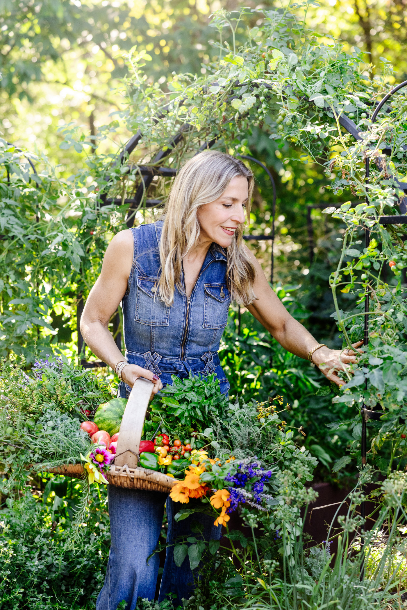 Nicole Burke picking vegetables in a beautiful garden