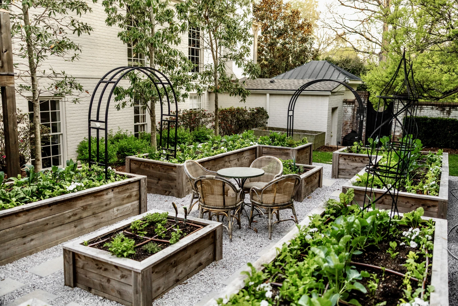 a large garden with a table and chairs in the middle