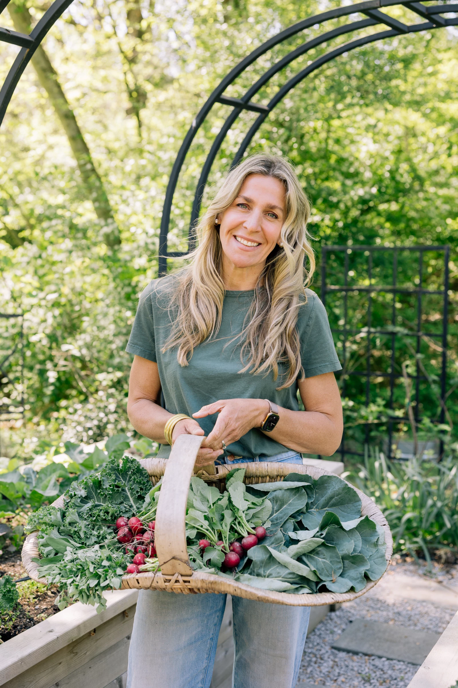 Nicole Burke holding a basket of fall-time vegetables